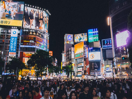 image shows a large crowd at Shibuya's famous scramble crossing